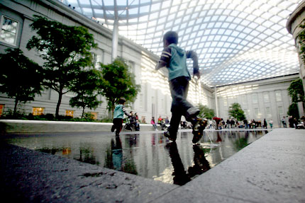 Children play in November 2007 at the Robert and Arlene Kogod Courtyard in Washington, DC, with its elegant glass canopy designed by world renowned architect Norman Foster. Photo credit: TIM SLOAN/AFP/Getty Images.