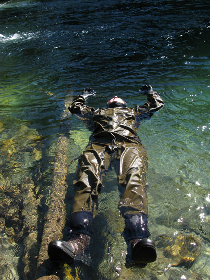 human in dry suit floating