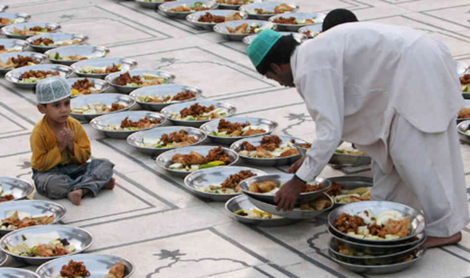 A Pakistani Muslim arranges food stuff for 'Iftar', a time to break the fast, on the first day of ho A Pakistani Muslim arranges food stuff for 'Iftar', a time to break the fast, on the first day of ho