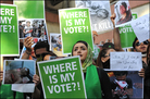 Supporters of Iranian Presidential candidate Mir Hossein Mousavi hold placards and pictures depict Supporters of Iranian Presidential candidate Mir Hossein Mousavi hold placards and pictures depict