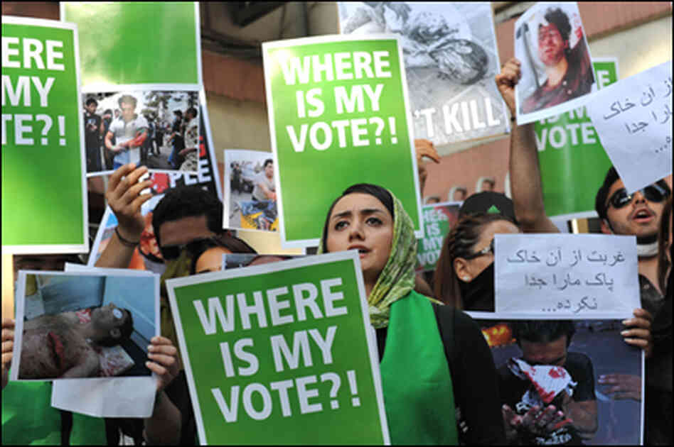 Supporters of Iranian Presidential candidate Mir Hossein Mousavi hold placards and pictures depict Supporters of Iranian Presidential candidate Mir Hossein Mousavi hold placards and pictures depict