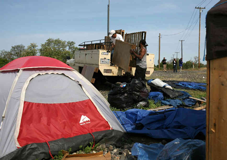 Earnest Thomas, a homeless man, moves his belongings at a homeless "tent city" in Sacramento, Calif. Earnest Thomas, a homeless man, moves his belongings at a homeless "tent city" in Sacramento, Calif.