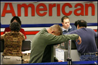 Exhausted from traveling, Johnny Sigmon waits in line after his American Airlines flight to Las Vegas was canceled on Wednesday at the Dallas-Fort Worth International Airport. Rick Gershon/Getty Images