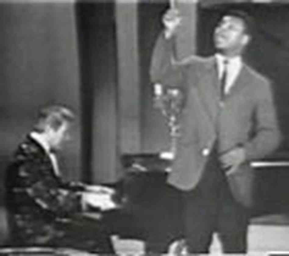 Pianist Liberace and boxer Cassius Clay (who later changed his name to Muhammad Ali) perform a song. Pianist Liberace and boxer Cassius Clay (who later changed his name to Muhammad Ali) perform a song.