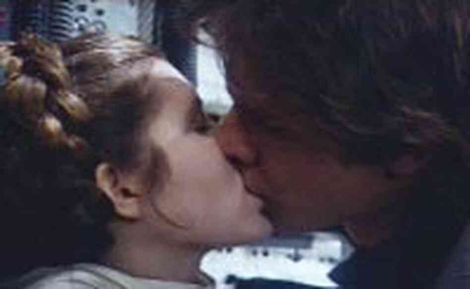 Han Solo (Harrison Ford) kisses Leia Organa (Carrie Fisher) in a romantic scene Han Solo (Harrison Ford) kisses Leia Organa (Carrie Fisher) in a romantic scene