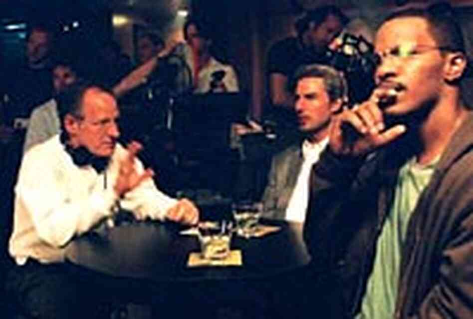 Director Michael Mann, left, talks with his two stars about a scene at a jazz club. Director Michael Mann, left, talks with his two stars about a scene at a jazz club.