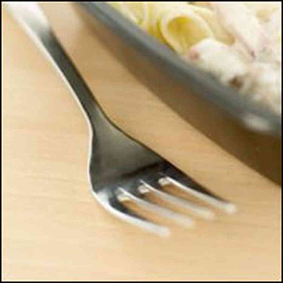 Fork and pasta in a container Fork and pasta in a container