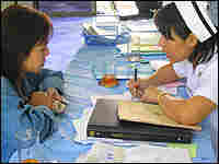 La, a 30-year-old Burmese woman living in the north of Thailand, is counseled by a nurse at Chiangse La, a 30-year-old Burmese woman living in the north of Thailand, is counseled by a nurse at Chiangse