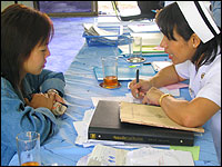 La, a 30-year-old Burmese woman living in the north of Thailand, is counseled by a nurse at Chiangse