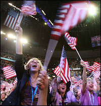 Delegates wave flags while watching former President Bill Clinton speak at the Democratic National Convention in Denver, Aug. 27, 2008.