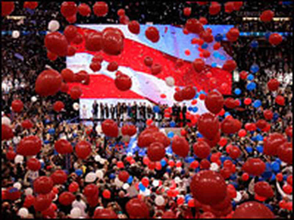 McCain and Palin stand on the stage with their families while balloons were dropped.