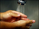 Hands being washed. Hands being washed.