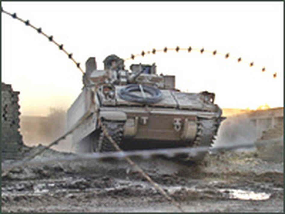 A U.S. Army Bradley armored vehicle rolls over a broken wall in Najaf, Aug.22, 2004. A U.S. Army Bradley armored vehicle rolls over a broken wall in Najaf, Aug.22, 2004.