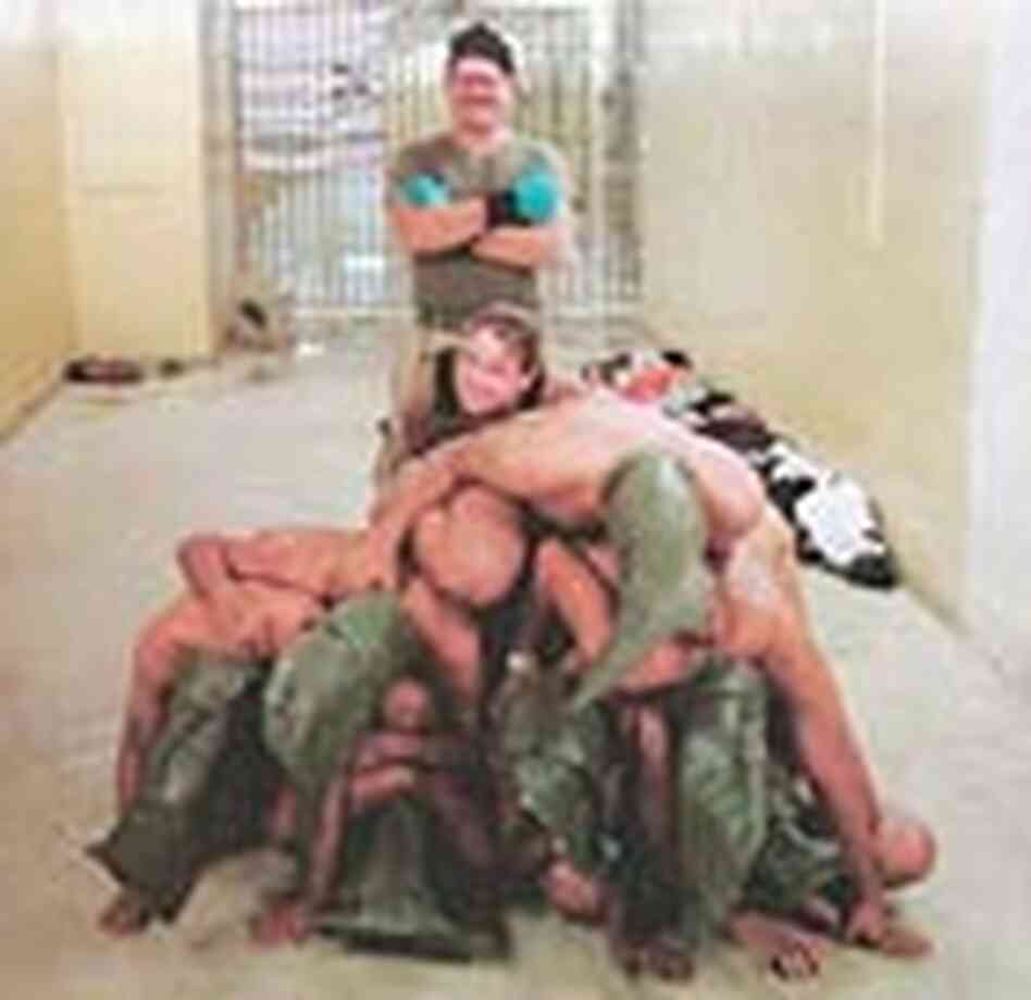 U.S. soldiers stand behind a pyramid of naked Iraqi prisoners at the Abu Ghraib prison near Baghdad. U.S. soldiers stand behind a pyramid of naked Iraqi prisoners at the Abu Ghraib prison near Baghdad.