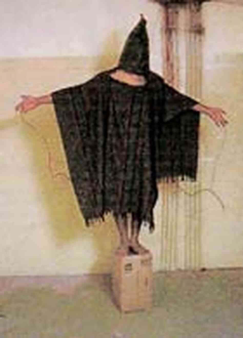 A hooded and wired Iraqi prisoner at Abu Ghraib prison. A hooded and wired Iraqi prisoner at Abu Ghraib prison.