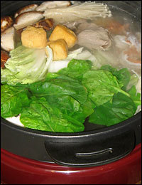 Beef, mushrooms, tofu, spinach, cabbage and shrimp simmer in this Chinese hot pot.
