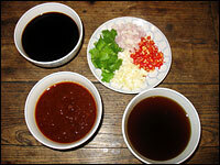 After cleaning and cutting the meats and vegetables, the only thing left to do is concoct a dipping sauce. Some common ingredients are soy sauce (clockwise from top left); cilantro, chili peppers, shallots and garlic; sesame oil and Chinese barbecue sauce (see below).