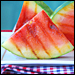 Grilled watermelon slices with a sugary glaze are perched on a white plate. Credit: Susan Russo for NPR