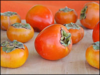 Don't confuse the Hachiya (center) with the Fuyu (left), or your persimmon-eating experience might be memorable for the wrong reasons. Hachiyas are nearly inedible unless very ripe, while Fuyus can be eaten hard or soft.