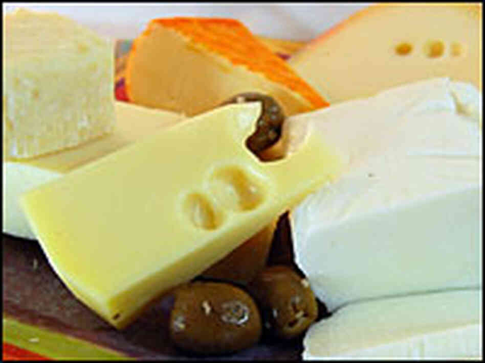 A platter of different cheeses and olives