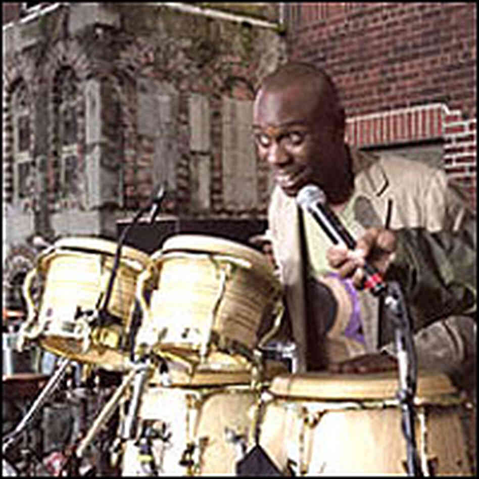 Dave Chappelle with the microphone in a scene from 'Block Party' Dave Chappelle with the microphone in a scene from 'Block Party'