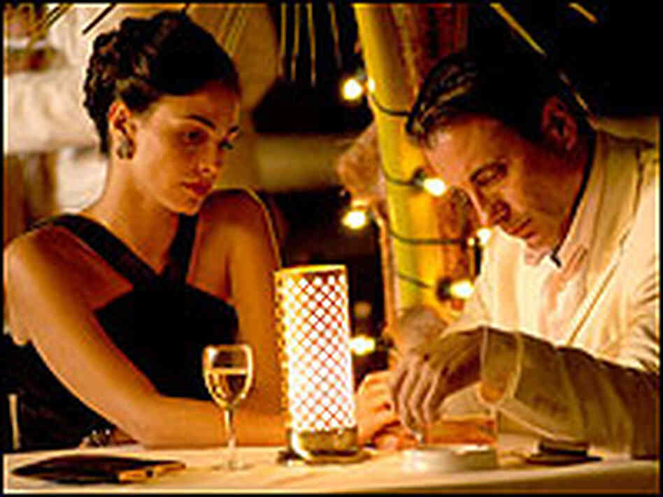 Andy Garcia and Ines Sastre dine at a nightclub table. Andy Garcia and Ines Sastre dine at a nightclub table.