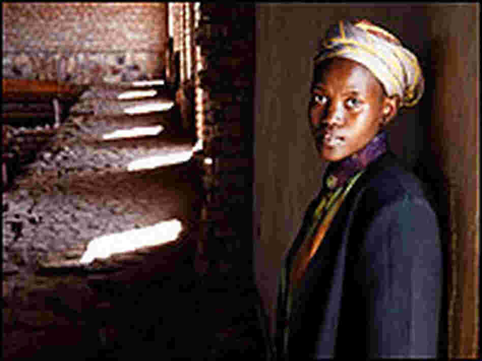 Mary, a Rwandan woman featured in the documentary, inside a church with light and shadow.
