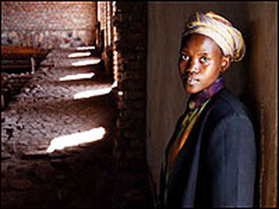 Mary, a Rwandan woman featured in the documentary, inside a church with light and shadow.