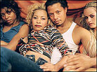 Terrence Howard, playing a pimp, is surrounded by three young women. Terrence Howard, playing a pimp, is surrounded by three young women.