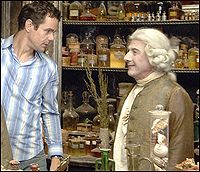 A bewigged Dustin Hoffman chats with director Tom Tykwer on the movie set.