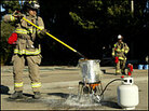 Firefighters fry a turkey outdoors, with full safety equipment. Firefighters fry a turkey outdoors, with full safety equipment.