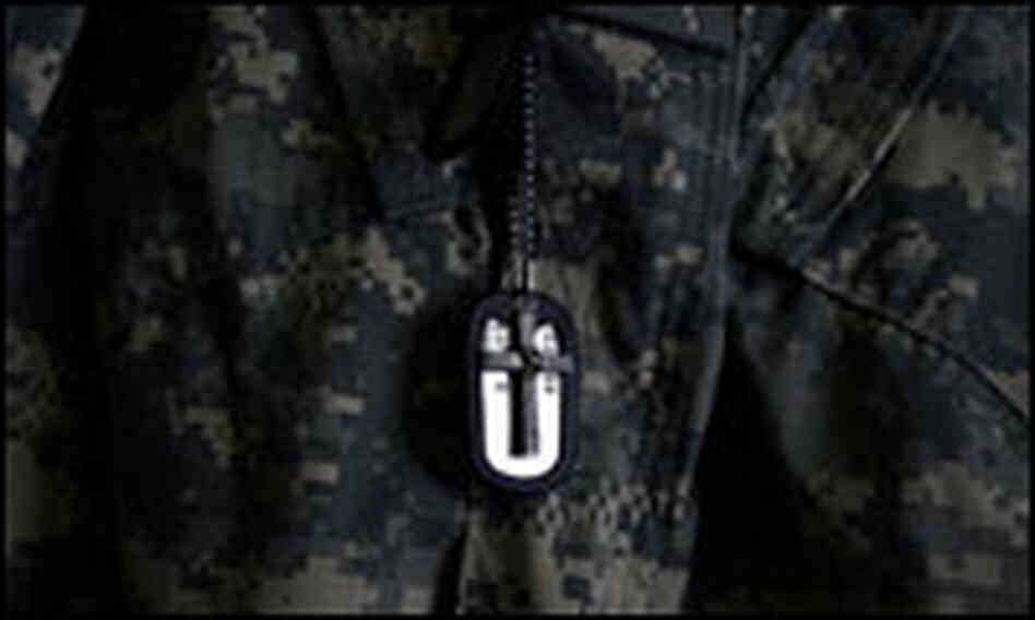 A cross hangs in front of Tyler Jones' dog tags.