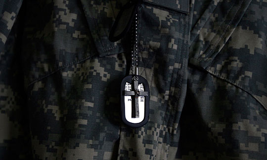 A cross hangs in front of Tyler Jones' dog tags.