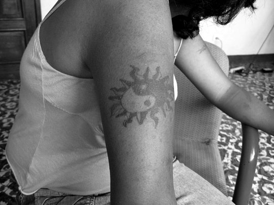 A 17-year-old former gang member, Babyface, says she covers her tattoos when she goes out.
