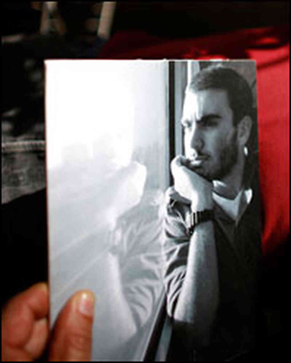Klok Sa'ar holds a photo of his son, Yuval, who is serving in the Israeli army