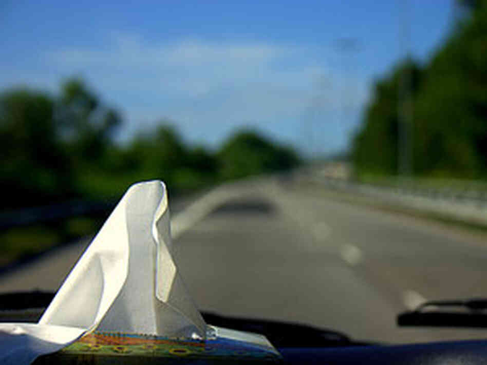 300 a box of tissues sits on a car's dashboard 300 a box of tissues sits on a car's dashboard