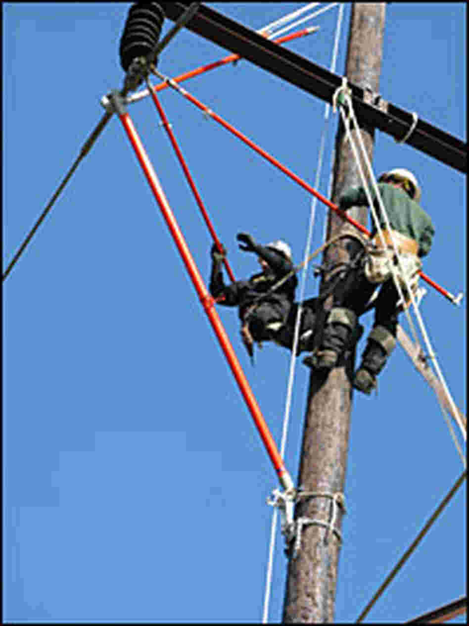 Electrical apprentices practice replacing a glass insulator
