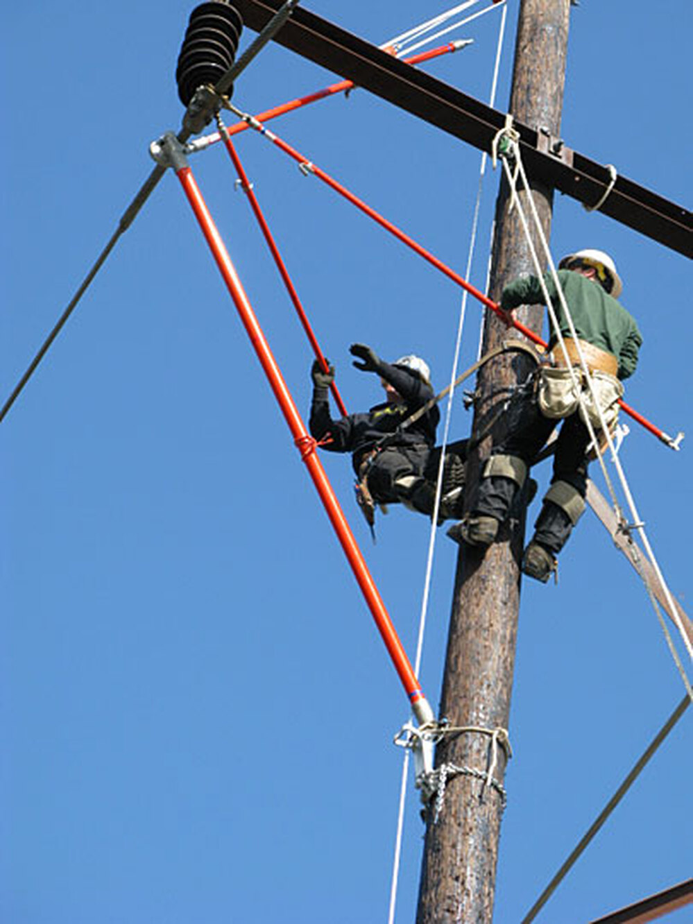 Electrical apprentices practice replacing a glass insulator