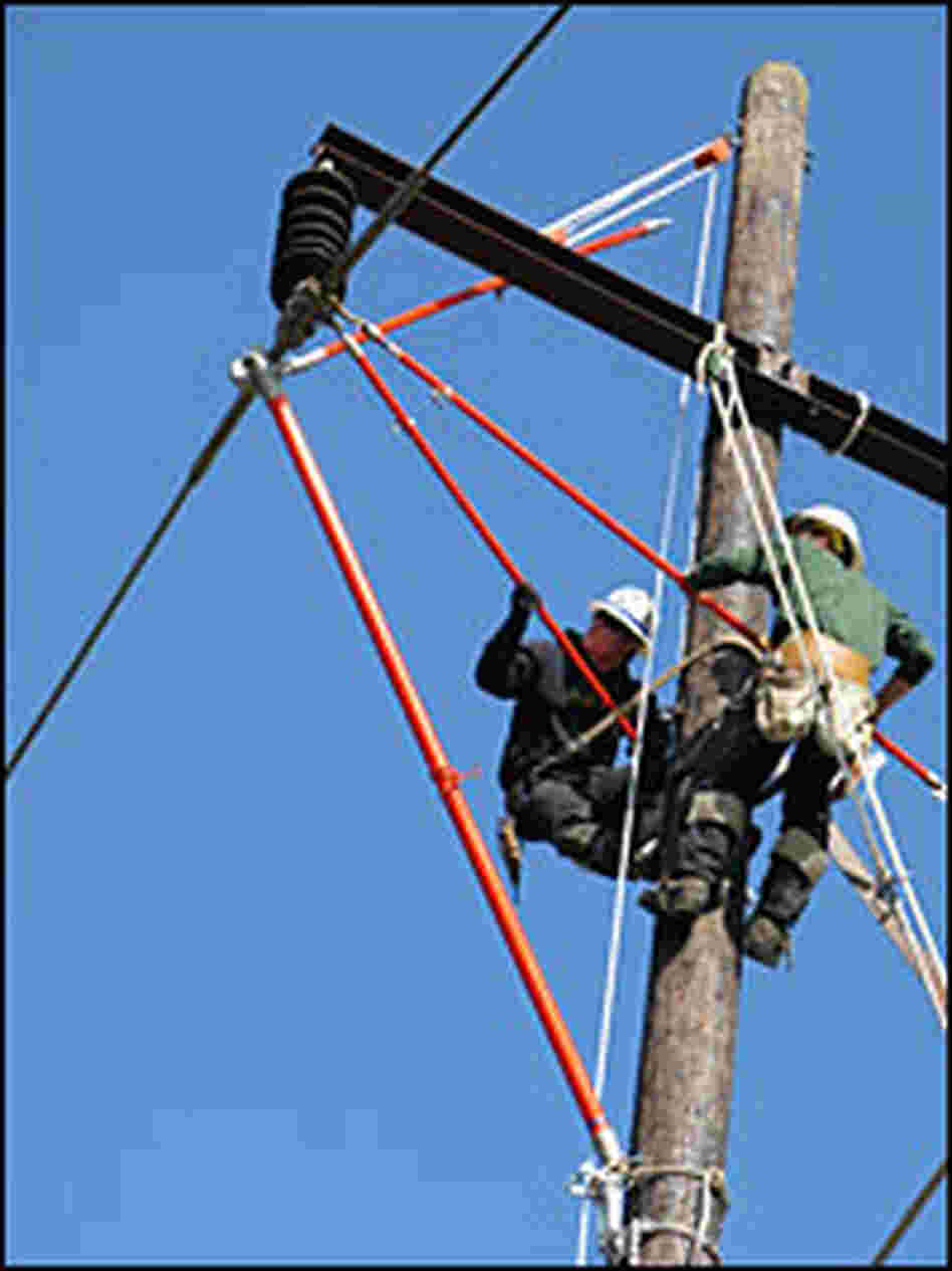 Workers practice repairing power lines.