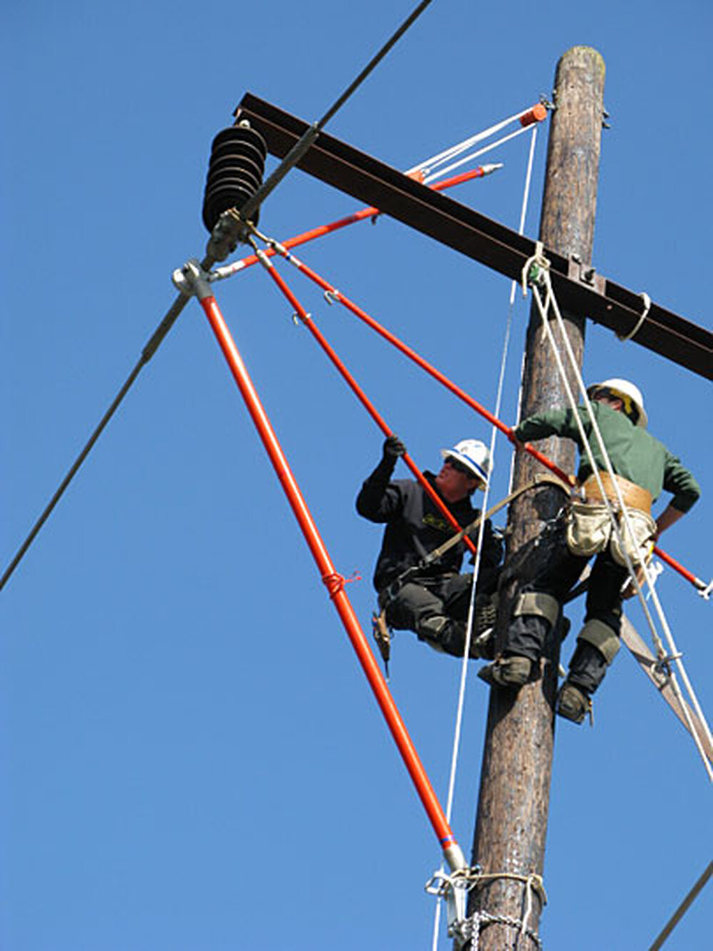 Workers practice repairing power lines.