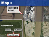 There are two nuclear reactors at Three Mile Island. The 1979 accident involved Unit 2, the two towers visible at the bottom. The upper two towers — Unit 1 — still operate today.