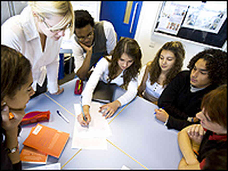 Teens work on a project at school. Teens work on a project at school.