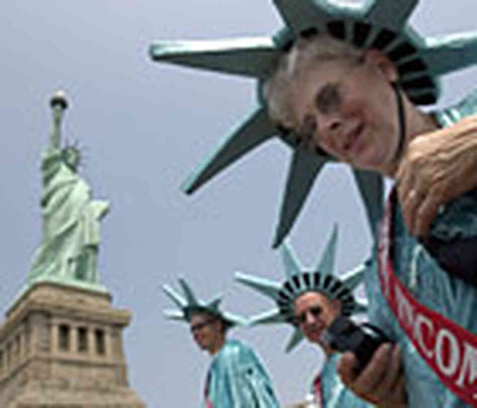 Statue of Liberty is seen after it reopened behind tourists wearing "Statue" costumes. Reuters Statue of Liberty is seen after it reopened behind tourists wearing "Statue" costumes. Reuters