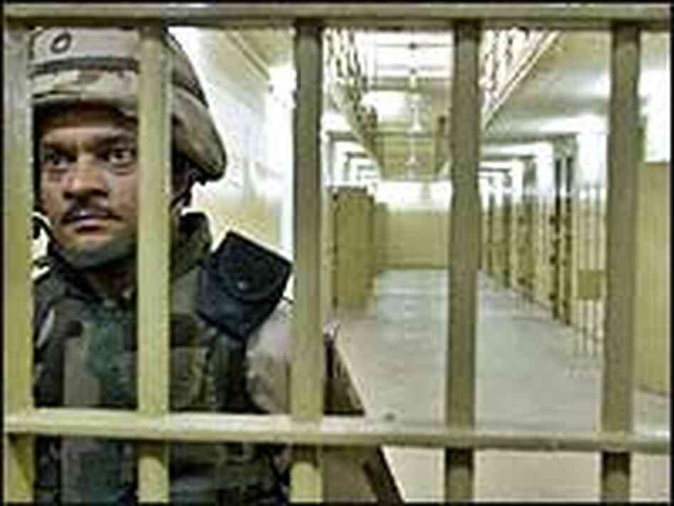 A U.S. soldier guards cells inside Abu Ghraib, May 2004. A U.S. soldier guards cells inside Abu Ghraib, May 2004.