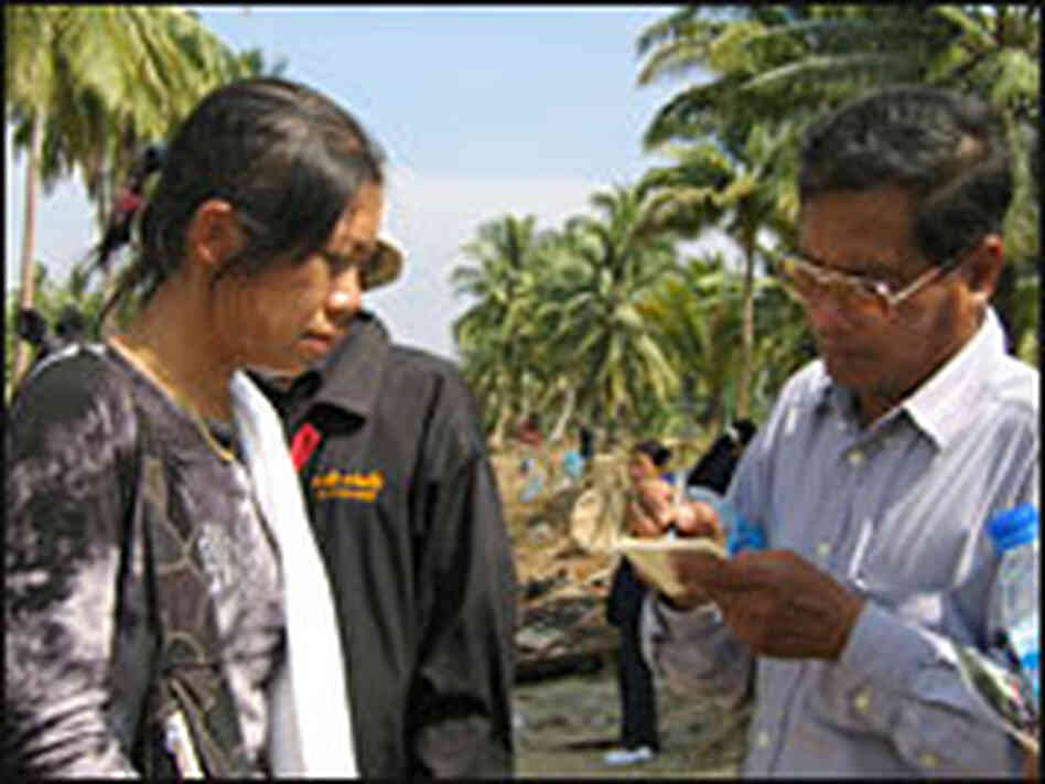 A woman gives a local official information about missing relatives on Thailand's Phuket Island. A woman gives a local official information about missing relatives on Thailand's Phuket Island.