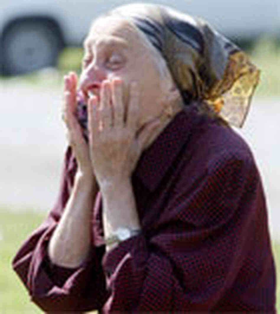 A relative of an 8-year-old hostage who died reacts in Baslan. A relative of an 8-year-old hostage who died reacts in Baslan.
