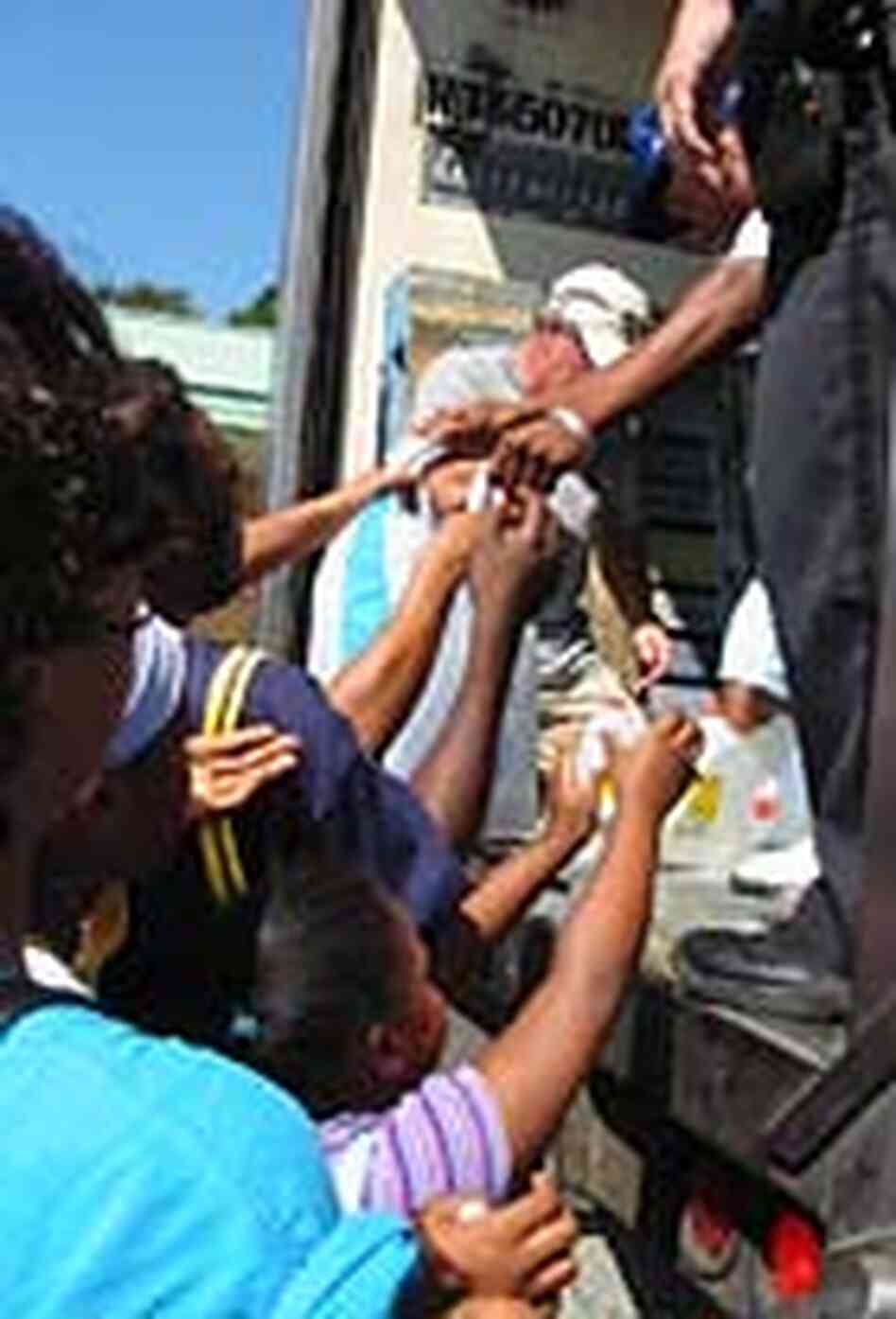 Residents of Gulf Shores, Ala., line up for ice and other supplies. Residents of Gulf Shores, Ala., line up for ice and other supplies.