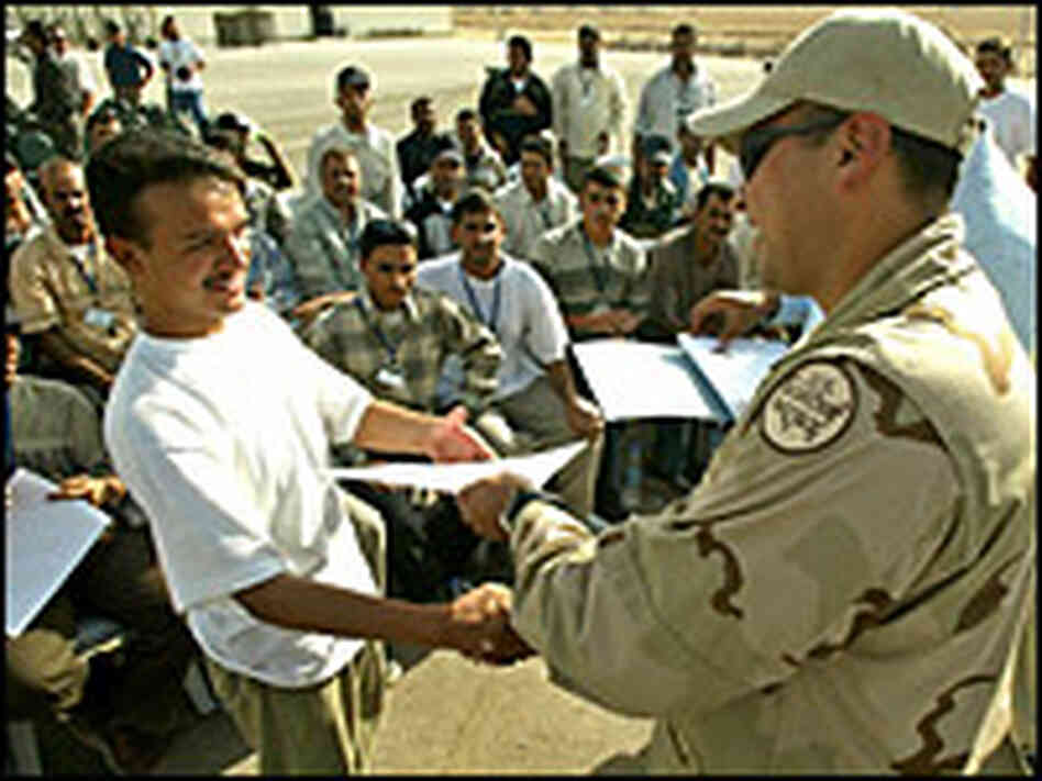 A new Iraqi border patrol police officer (L) receives his certificate. Credit: Reuters A new Iraqi border patrol police officer (L) receives his certificate. Credit: Reuters