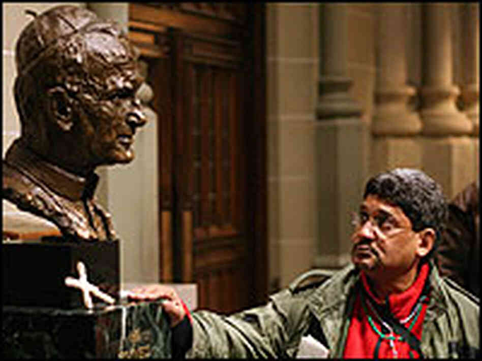 A visitor to St. Patrick's Cathedral in New York gazes at a statue of the pope. A visitor to St. Patrick's Cathedral in New York gazes at a statue of the pope.