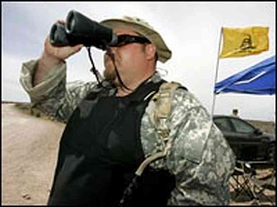 Minuteman Project volunteer JT Ready uses binoculars to scan for potential illegal immigrants. Minuteman Project volunteer JT Ready uses binoculars to scan for potential illegal immigrants.